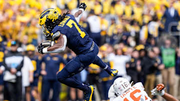 Michigan running back Donovan Edwards (7) runs for a first down against Texas defensive back Michael Taaffe (16) during the first half at Michigan Stadium in Ann Arbor on Saturday, September 7, 2024.