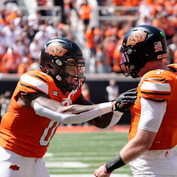 Oklahoma State's Alan Bowman (7) and Ollie Gordon II (0) celebrate in the second half of the college football game between the Oklahoma State Cowboys and the Arkansas Razorbacks at Boone Pickens Stadium in Stillwater, Okla.,, Saturday, Sept., 7, 2024.