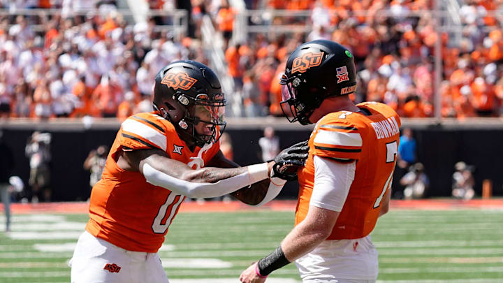 Oklahoma State's Alan Bowman (7) and Ollie Gordon II (0) celebrate in the second half of the college football game between the Oklahoma State Cowboys and the Arkansas Razorbacks at Boone Pickens Stadium in Stillwater, Okla.,, Saturday, Sept., 7, 2024.