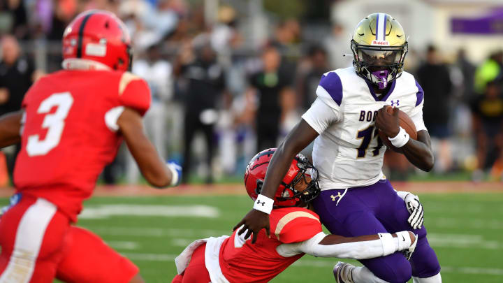 Cardinal Mooney defender Laron Dues (#6) wraps up the legs of Booker High quarterback Joel Morris (#11). The Cardinal Mooney Catholic High School Cougars hosted the Booker High Tornadoes Friday night, Aug. 16, 2024 in the first pre-season football game of the school year.