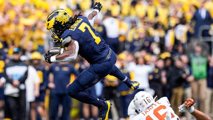 Michigan running back Donovan Edwards (7) runs for a first down against Texas defensive back Michael Taaffe (16) during the first half at Michigan Stadium in Ann Arbor on Saturday, September 7, 2024.