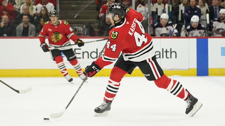 Dec 1, 2024; Chicago, Illinois, USA; Chicago Blackhawks defenseman Wyatt Kaiser (44) shoots the puck against the Columbus Blue Jackets during the first period at United Center. Mandatory Credit: David Banks-Imagn Images