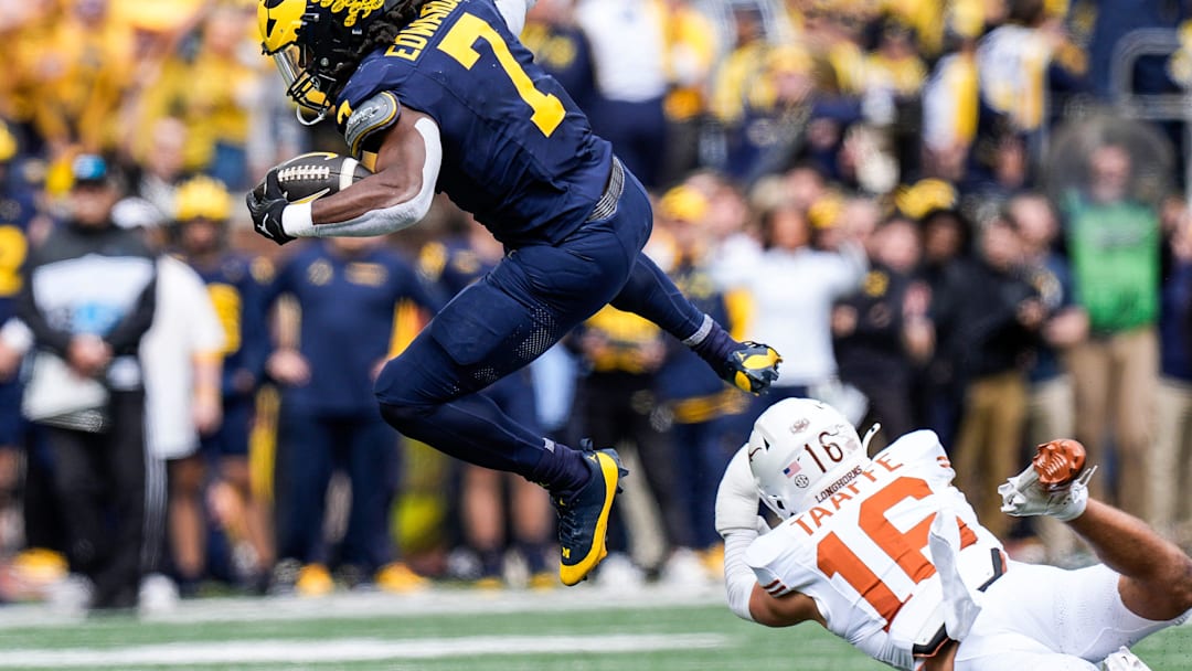 Michigan running back Donovan Edwards (7) runs for a first down against Texas defensive back Michael Taaffe (16) during the first half at Michigan Stadium in Ann Arbor on Saturday, September 7, 2024.