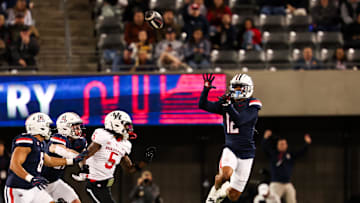 Nov 15, 2024; Tucson, Arizona, USA; Arizona Wildcats defensive back Genesis Smith (12) intercepts the ball during the second quarter against the Houston Cougars at Arizona Stadium. Mandatory Credit: Aryanna Frank-Imagn Images