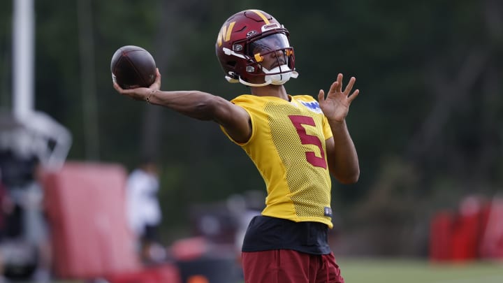 Jul 26, 2024; Ashburn, VA, USA; Washington Commanders quarterback Jayden Daniels (5) passes the ball during warmup before day three of training camp at Commanders Park. Mandatory Credit: Geoff Burke-USA TODAY Sports