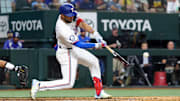 Jul 2, 2024; Arlington, Texas, USA; Texas Rangers third baseman Jonathan Ornelas (21) hits an RBI double during the sixth inning against the San Diego Padres at Globe Life Field. 