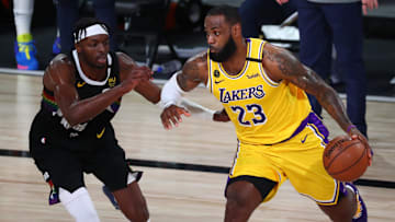 Sep 24, 2020; Lake Buena Vista, Florida, USA; Los Angeles Lakers forward LeBron James (23) drives the ball around Denver Nuggets forward Jerami Grant (9) during the second half in game four of the Western Conference Finals of the 2020 NBA Playoffs at AdventHealth Arena. Mandatory Credit: Kim Klement-Imagn Images