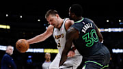 Apr 1, 2025; Denver, Colorado, USA; Denver Nuggets center Nikola Jokic (15) is fouled by Minnesota Timberwolves forward Julius Randle (30) in the fourth quarter at Ball Arena. Mandatory Credit: Isaiah J. Downing-Imagn Images