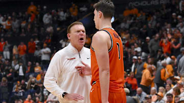 Dec 6, 2025; Nashville, Tennessee, USA;  Illinois Fighting Illini head coach Brad Underwood talks with forward David Mirkovic (0) against the Tennessee Volunteers during the second half at Bridgestone Arena. Mandatory Credit: Steve Roberts-Imagn Images