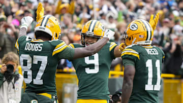 Oct 13, 2024; Green Bay, Wisconsin, USA;  Green Bay Packers wide receiver Romeo Doubs (87) celebrates with wide receivers Christian Watson (9) and Jayden Reed (11) after scoring a touchdown during the third quarter against the Arizona Cardinals at Lambeau Field. Mandatory Credit: Jeff Hanisch-Imagn Images
