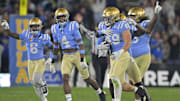 Nov 8, 2024; Pasadena, California, USA;   UCLA Bruins linebacker Carson Schwesinger (49) and teammates celebrate after an interception in the second half against the Iowa Hawkeyes at the Rose Bowl. Mandatory Credit: Jayne Kamin-Oncea-Imagn Images