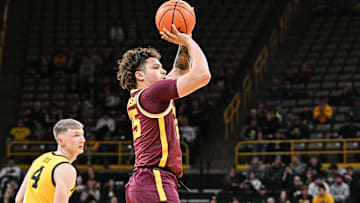 Jan 21, 2025; Iowa City, Iowa, USA; Minnesota Golden Gophers guard Lu'Cye Patterson (25) shoots a three-point basket as Iowa Hawkeyes guard Josh Dix (4) looks on during the first half at Carver-Hawkeye Arena. Mandatory Credit: Jeffrey Becker-Imagn Images