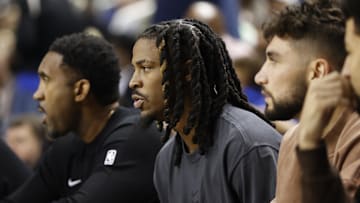 Oct 15, 2025; Greensboro, North Carolina, USA; Memphis Grizzlies guard Ja Morant watches from the bench during the second quarter against the Charlotte Hornets at First Horizon Coliseum. Mandatory Credit: Brian Westerholt-Imagn Images