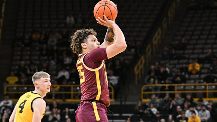 Jan 21, 2025; Iowa City, Iowa, USA; Minnesota Golden Gophers guard Lu'Cye Patterson (25) shoots a three-point basket as Iowa Hawkeyes guard Josh Dix (4) looks on during the first half at Carver-Hawkeye Arena. Mandatory Credit: Jeffrey Becker-Imagn Images