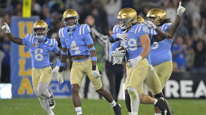 Nov 8, 2024; Pasadena, California, USA; UCLA Bruins linebacker Carson Schwesinger (49) and teammates celebrate after an interception in the second half against the Iowa Hawkeyes at the Rose Bowl. Mandatory Credit: Jayne Kamin-Oncea-Imagn Images Nov 8, 2024; Pasadena, California, USA; UCLA Bruins linebacker Carson Schwesinger (49) and teammates celebrate after an interception in the second half against the Iowa Hawkeyes at the Rose Bowl. Mandatory Credit: Jayne Kamin-Oncea-Imagn Images