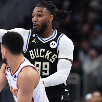 Feb 26, 2023; Milwaukee, Wisconsin, USA; Milwaukee Bucks forward Jae Crowder (99) plays defense against Phoenix Suns guard Devin Booker (1) in the second half at Fiserv Forum. Mandatory Credit: Michael McLoone-USA TODAY Sports