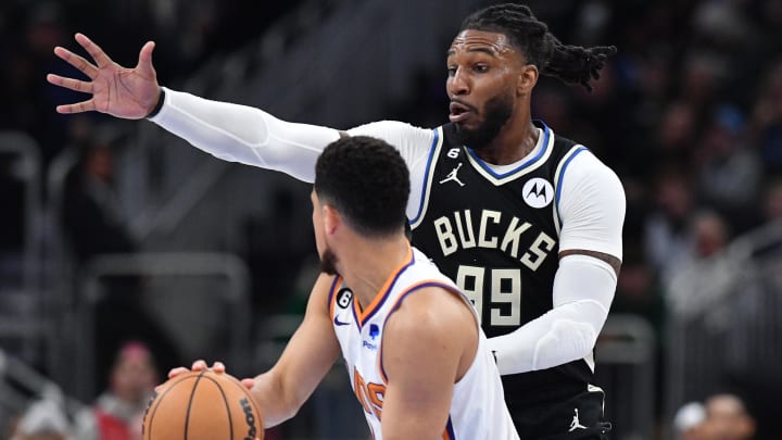 Feb 26, 2023; Milwaukee, Wisconsin, USA; Milwaukee Bucks forward Jae Crowder (99) plays defense against Phoenix Suns guard Devin Booker (1) in the second half at Fiserv Forum. Mandatory Credit: Michael McLoone-USA TODAY Sports