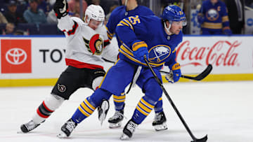 Nov 5, 2024; Buffalo, New York, USA;  Buffalo Sabres defenseman Owen Power (25) skates with the puck as Ottawa Senators center Nick Cousins (21) tries to defend during the third period at KeyBank Center. Mandatory Credit: Timothy T. Ludwig-Imagn Images