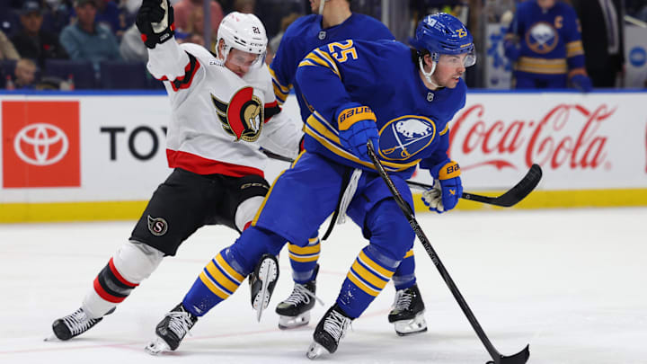 Nov 5, 2024; Buffalo, New York, USA;  Buffalo Sabres defenseman Owen Power (25) skates with the puck as Ottawa Senators center Nick Cousins (21) tries to defend during the third period at KeyBank Center. Mandatory Credit: Timothy T. Ludwig-Imagn Images