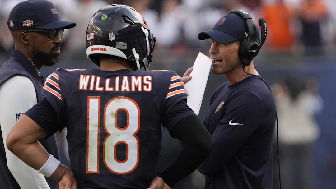 Sep 21, 2025; Chicago, Illinois, USA; Chicago Bears head coach Ben Johnson talks with quarterback Caleb Williams (18) against the Dallas Cowboys during the second half at Soldier Field. Mandatory Credit: David Banks-Imagn Images