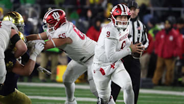 Dec 20, 2024; Notre Dame, Indiana, USA; Indiana Hoosiers quarterback Kurtis Rourke (9) scrambles during the second half against the Notre Dame Fighting Irish at Notre Dame Stadium. Mandatory Credit: Trevor Ruszkowski-Imagn Images