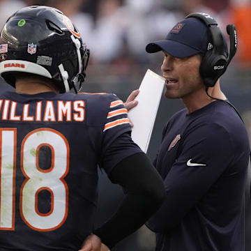 Sep 21, 2025; Chicago, Illinois, USA; Chicago Bears head coach Ben Johnson talks with quarterback Caleb Williams (18) against the Dallas Cowboys during the second half at Soldier Field. Mandatory Credit: David Banks-Imagn Images