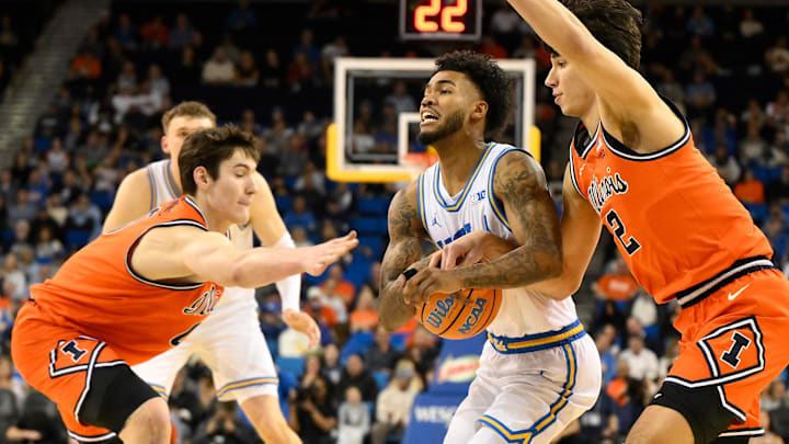 Feb 21, 2026; Los Angeles, California, USA; Illinois forward David Mirkovic (0) and guard Andrej Stojakovic (2) defend UCLA guard Donovan Dent (2) during the first half at Pauley Pavilion presented by Wescom Financial. Mandatory Credit: Robert Hanashiro-Imagn Images