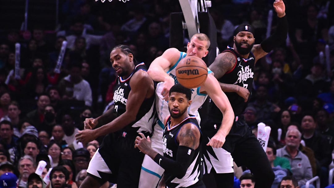 Dec 21, 2022; Los Angeles, California, USA; Charlotte Hornets center Mason Plumlee (center, top) watches the ball alongside Los Angeles Clippers forward Paul George (bottom), forward Kawhi Leonard (left) and forward Marcus Morris (right) during the third quarter at Crypto.com Arena. Mandatory Credit: Richard Mackson-Imagn Images