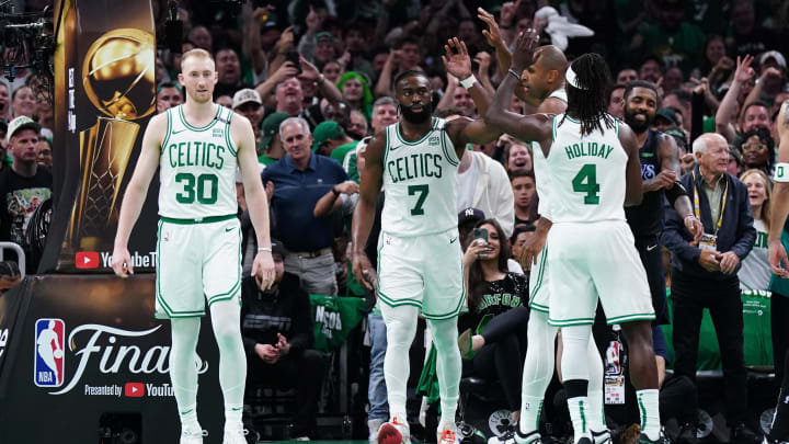 Jun 6, 2024; Boston, Massachusetts, USA; Boston Celtics guard Jaylen Brown (7) and center Al Horford (42) and guard Jrue Holiday (4) react in the third quarter against the Dallas Mavericks during game one of the 2024 NBA Finals at TD Garden. Mandatory Credit: David Butler II-USA TODAY Sports