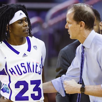Then Washington coach Mike Hopkins talks with guard Keyon Menifield (23) during a 2023 game. 