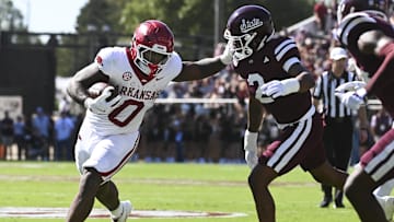 Oct 26, 2024; Starkville, Mississippi, USA;  Arkansas Razorbacks running back Braylen Russell (0) runs the ball while defended by Mississippi State Bulldogs safety Isaac Smith (2) during the first quarter at Davis Wade Stadium at Scott Field. Mandatory Credit: Matt Bush-Imagn Images