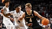 Feb 26, 2025; College Station, Texas, USA; Vanderbilt Commodores guard Grant Huffman (4) drives against Texas A&M Aggies guard Wade Taylor IV (4) during the second half at Reed Arena. Mandatory Credit: Maria Lysaker-Imagn Images 