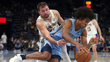 Oct 31, 2025; Memphis, Tennessee, USA; Memphis Grizzlies forward Jaylen Wells (0) drives to the basket as Los Angeles Lakers guard Luka Doncic (77) defends during the fourth quarter at FedExForum. Mandatory Credit: Petre Thomas-Imagn Images