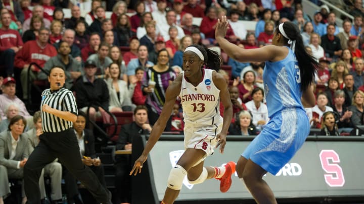 Apr 1, 2014; Stanford, CA, USA; Stanford Cardinal forward Chiney Ogwumike (13) dribbles the ball against North Carolina Tar Heels forward Xylina McDaniel (34) during the second half in the finals of the Stanford regional in the 2014 NCAA Tournament at at Maples Pavilion. The Stanford Cardinal defeated the North Carolina Tar Heels 74-65. Mandatory Credit: Kelley L Cox-USA TODAY Sports