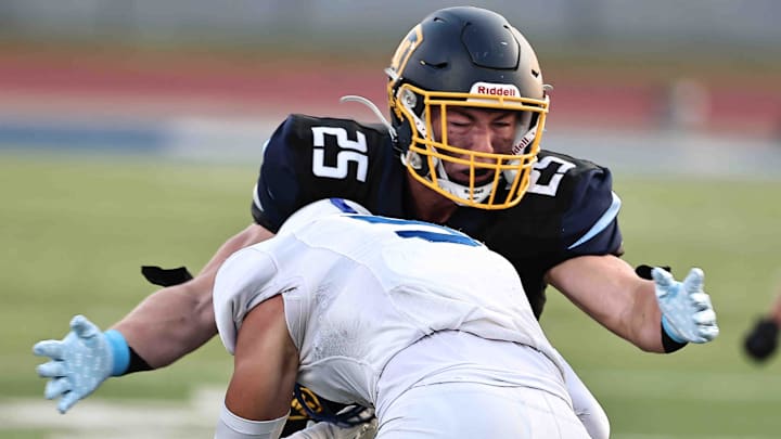 Moeller tackles St. Xavier during their football game Friday, Sept. 19, 2025. Moeller tackles St. Xavier during their football game Friday, Sept. 19, 2025.