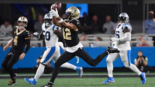 New Orleans Saints wide receiver Chris Olave (12) catches a deep pass against the Carolina Panthers  