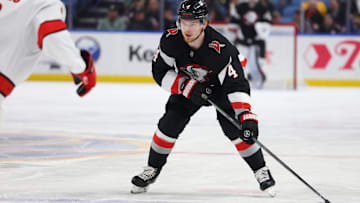 Apr 8, 2025; Buffalo, New York, USA;  Buffalo Sabres defenseman Bowen Byram (4) looks to make a pass during the second period against the Carolina Hurricanes at KeyBank Center. Mandatory Credit: Timothy T. Ludwig-Imagn Images