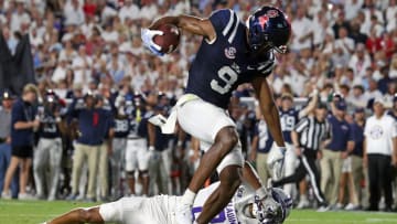 Aug 31, 2024; Oxford, Mississippi, USA; Mississippi Rebels wide receiver Tre Harris (9) stiff arms Furman Paladins defensive back Jaylen Moson (8) as he crosses the goal-line during the first half at Vaught-Hemingway Stadium. Mandatory Credit: Petre Thomas-USA TODAY Sports