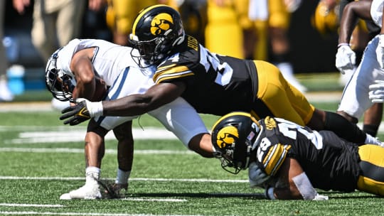 Sep 2, 2023; Iowa City, Iowa, USA; Iowa Hawkeyes linebacker Jay Higgins (34) and defensive back Sebastian Castro (29) tackle Utah State Aggies wide receiver Terrell Vaughn (0) during the third quarter at Kinnick Stadium. Mandatory Credit: Jeffrey Becker-USA TODAY Sports