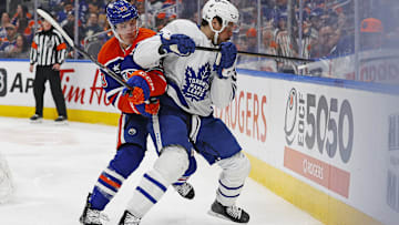 Feb 1, 2025; Edmonton, Alberta, CAN; Toronto Maple Leafs forward Auston Matthews (34) and Edmonton Oilers forward Ryan Nugent-Hopkins (93) battle along the boards for a loose puck during the second period at Rogers Place. Mandatory Credit: Perry Nelson-Imagn Images