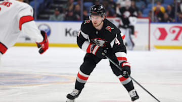 Apr 8, 2025; Buffalo, New York, USA;  Buffalo Sabres defenseman Bowen Byram (4) looks to make a pass during the second period against the Carolina Hurricanes at KeyBank Center. Mandatory Credit: Timothy T. Ludwig-Imagn Images