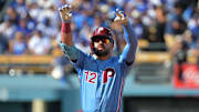 Oct 9, 2025; Los Angeles, California, USA; Philadelphia Phillies left fielder Kyle Schwarber (12) reacts after a double in the first inning against the Los Angeles Dodgers during game four of the NLDS round for the 2025 MLB playoffs at Dodger Stadium. Mandatory Credit: Jayne Kamin-Oncea-Imagn Images