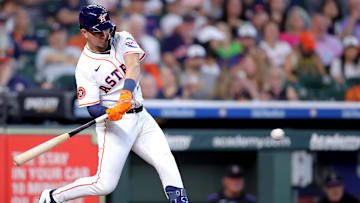 Aug 28, 2025; Houston, Texas, USA; Houston Astros second baseman Ramon Urias (29) hits a single against the Colorado Rockies during the third inning at Daikin Park. 
