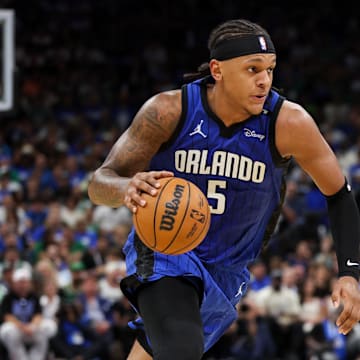Apr 27, 2025; Orlando, Florida, USA; Orlando Magic forward Paolo Banchero (5) is guarded by Boston Celtics guard Derrick White (9) in the second quarter during game four of first round for the 2025 NBA Playoffs at Kia Center. Mandatory Credit: Nathan Ray Seebeck-Imagn Images