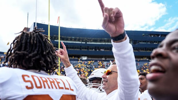 Texas head coach Steve Sarkisian and Texas players celebrate 31-12 win over Michigan at Michigan Stadium in Ann Arbor on Satu