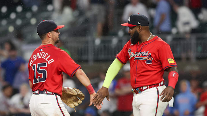 Sep 13, 2024; Atlanta, Georgia, USA; Atlanta Braves second baseman Whit Merrifield (15) and designated hitter Marcell Ozuna (20) celebrate after a victory over the Los Angeles Dodgers at Truist Park. Mandatory Credit: Brett Davis-Imagn Images
