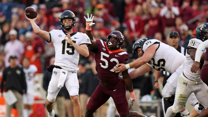 Oct 14, 2023; Blacksburg, Virginia, USA; Wake Forest Demon Deacons quarterback Michael Kern (15) throws a pass against Virginia Tech Hokies defensive lineman Antwaun Powell-Ryland (52) during the fourth quarter at Lane Stadium. Mandatory Credit: Peter Casey-USA TODAY Sports