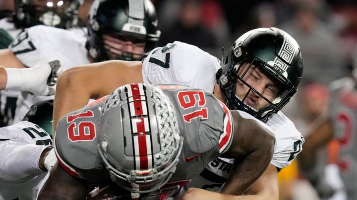 Nov. 11, 2023; Columbus, Oh., USA; 
Ohio State Buckeyes running back Chip Trayanum (19) is tackled by Michigan State Spartans linebacker Cal Haladay (27) during the first half of Saturday's NCAA Division I football game against the Michigan State Spartans.