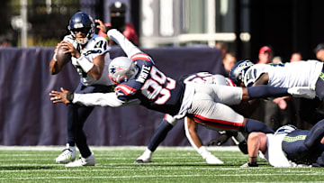 Sep 15, 2024; Foxborough, Massachusetts, USA; New England Patriots defensive end Keion White (99) sacks Seattle Seahawks quarterback Geno Smith (7) during the second half at Gillette Stadium.