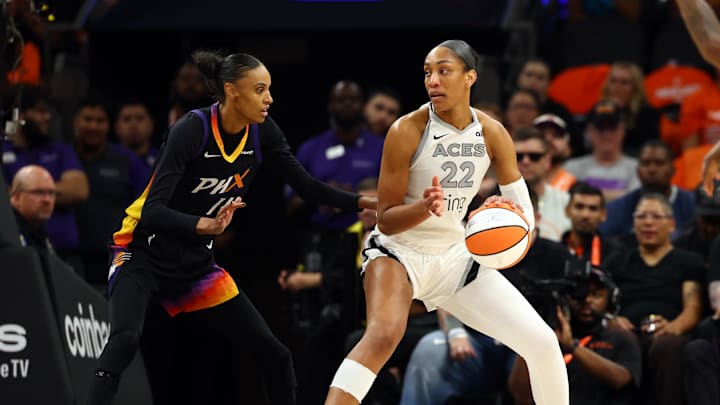 Oct 8, 2025; Phoenix, Arizona, USA; Las Vegas Aces center A'ja Wilson (22) against Phoenix Mercury forward DeWanna Bonner (14) during game three of the 2025 WNBA Finals at PHX Arena. Mandatory Credit: Mark J. Rebilas-Imagn Images